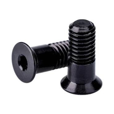 Two black Garbaruk derailleur pulley bolts, one lying on its side showing the hex socket in its head.